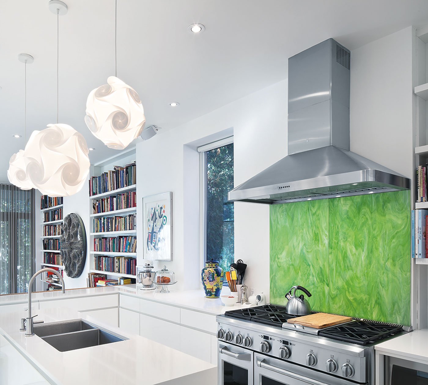 Annex home renovation, Cambria quartz–topped cabinetry conceals acres of storage. Lights from Allmodern.com; Italian glass backsplash