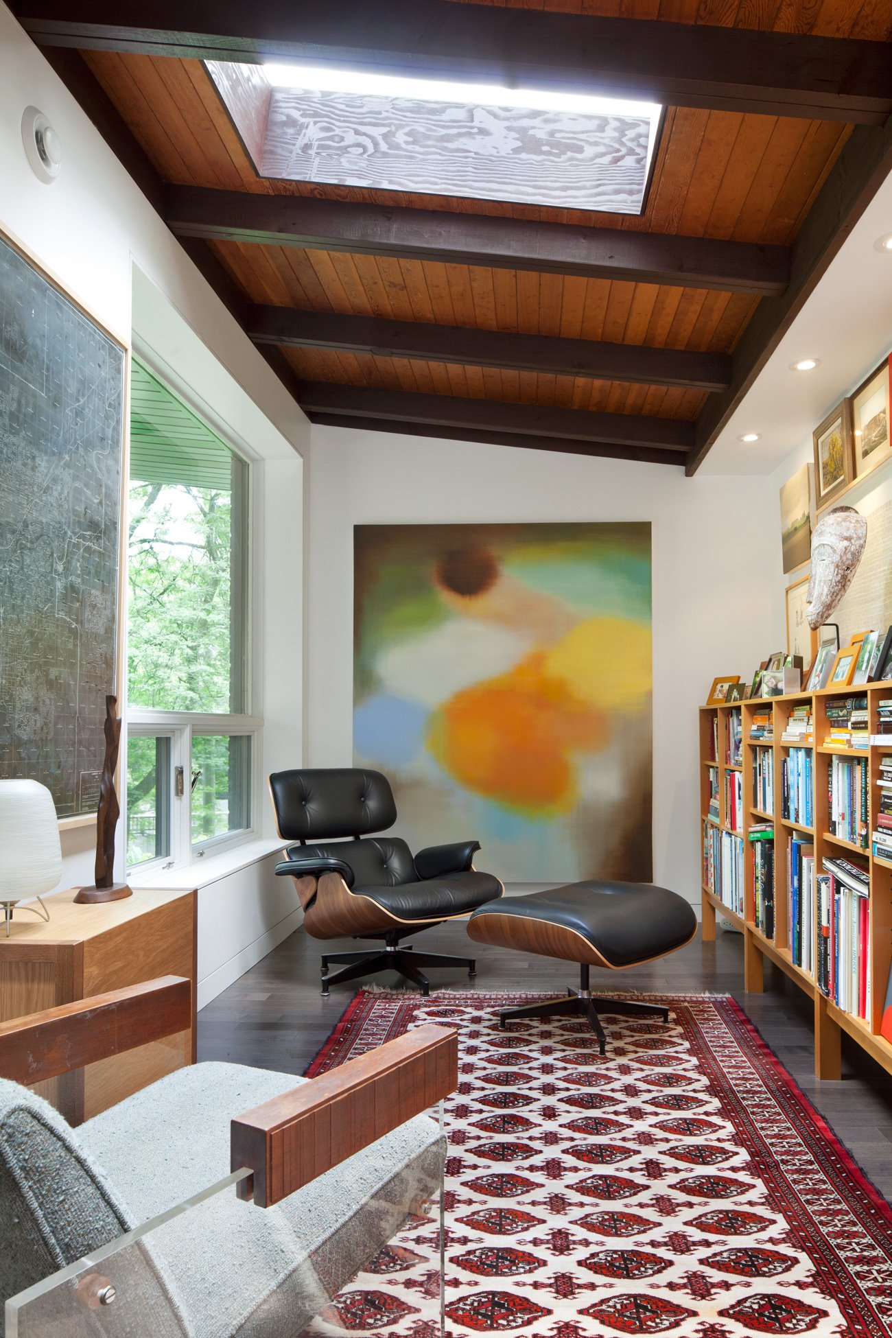 Home Library Ideas Design Designlines Magazine mid century modern furniture in a room lit by a new skylight.