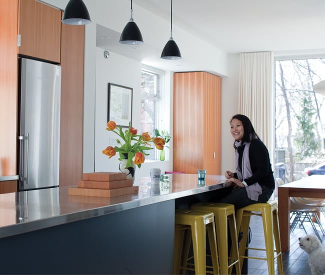 Christina Yu sits on a Marais stools in the kitchen