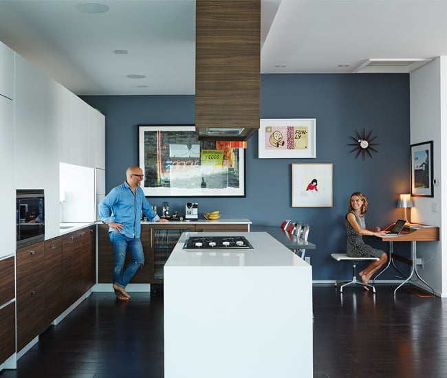 A couple, make and female, are having a discussion in a kitchen sharing space with the living room | Kitchen Design Ideas