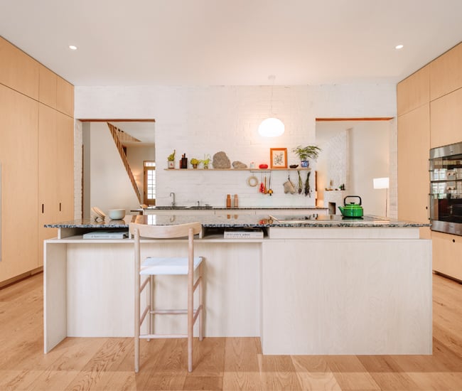 A maple-clad kitchen’s seamless wall of cabinets, big island as focus point | Kitchen design Ideas