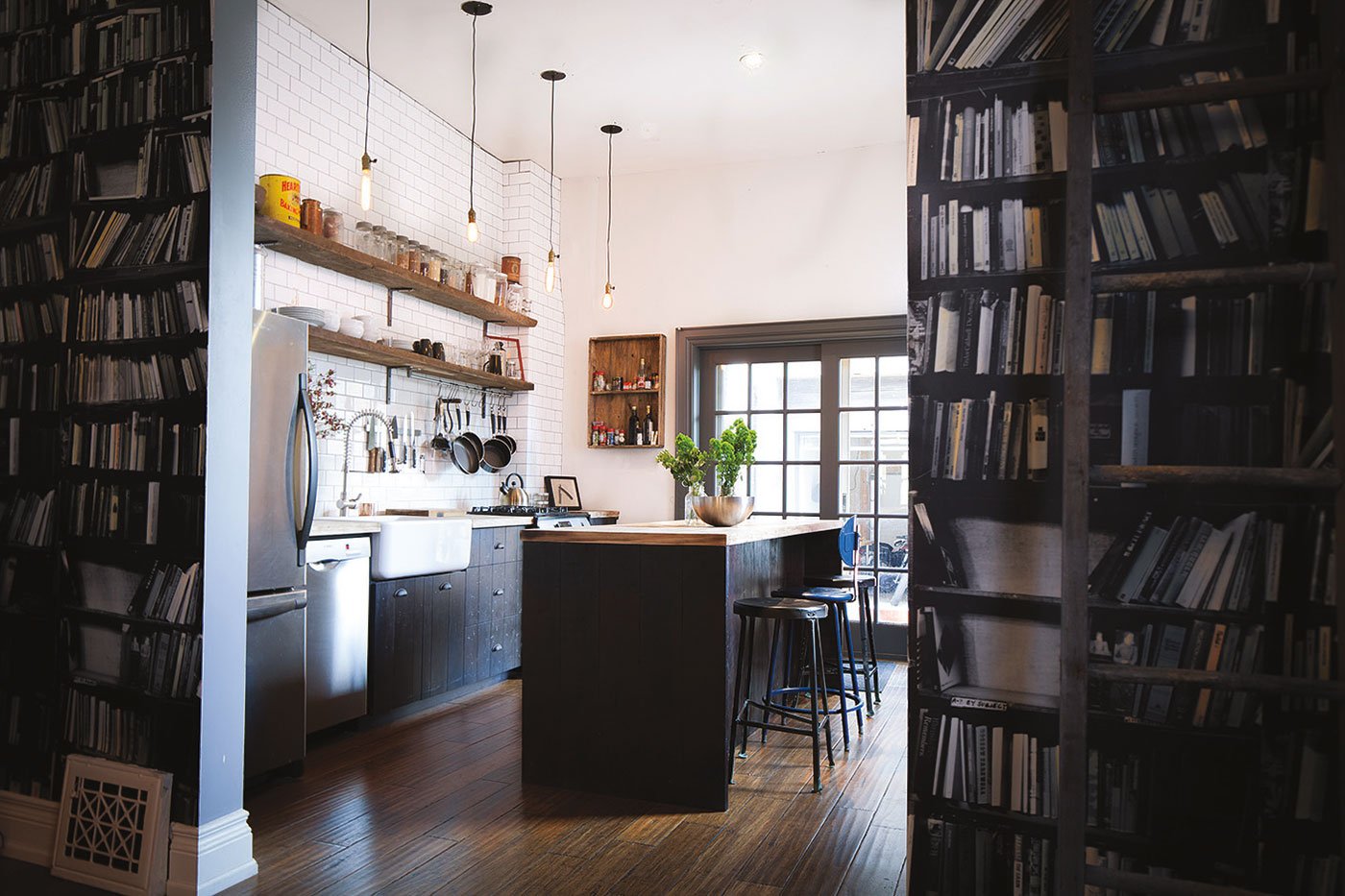 A backsplash subway tile offset dark wooden cabinetry
