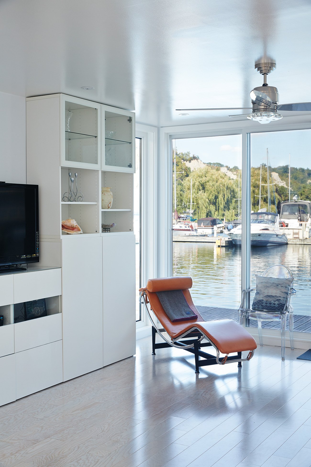 Sliding glass doorss maximizes views of the marina, LC4 Chaise and cabinets from IKEA, Toronto Float Homes