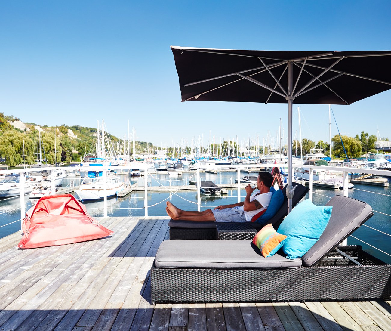 Paul Peic on his floating home ample deck with view on the marina
