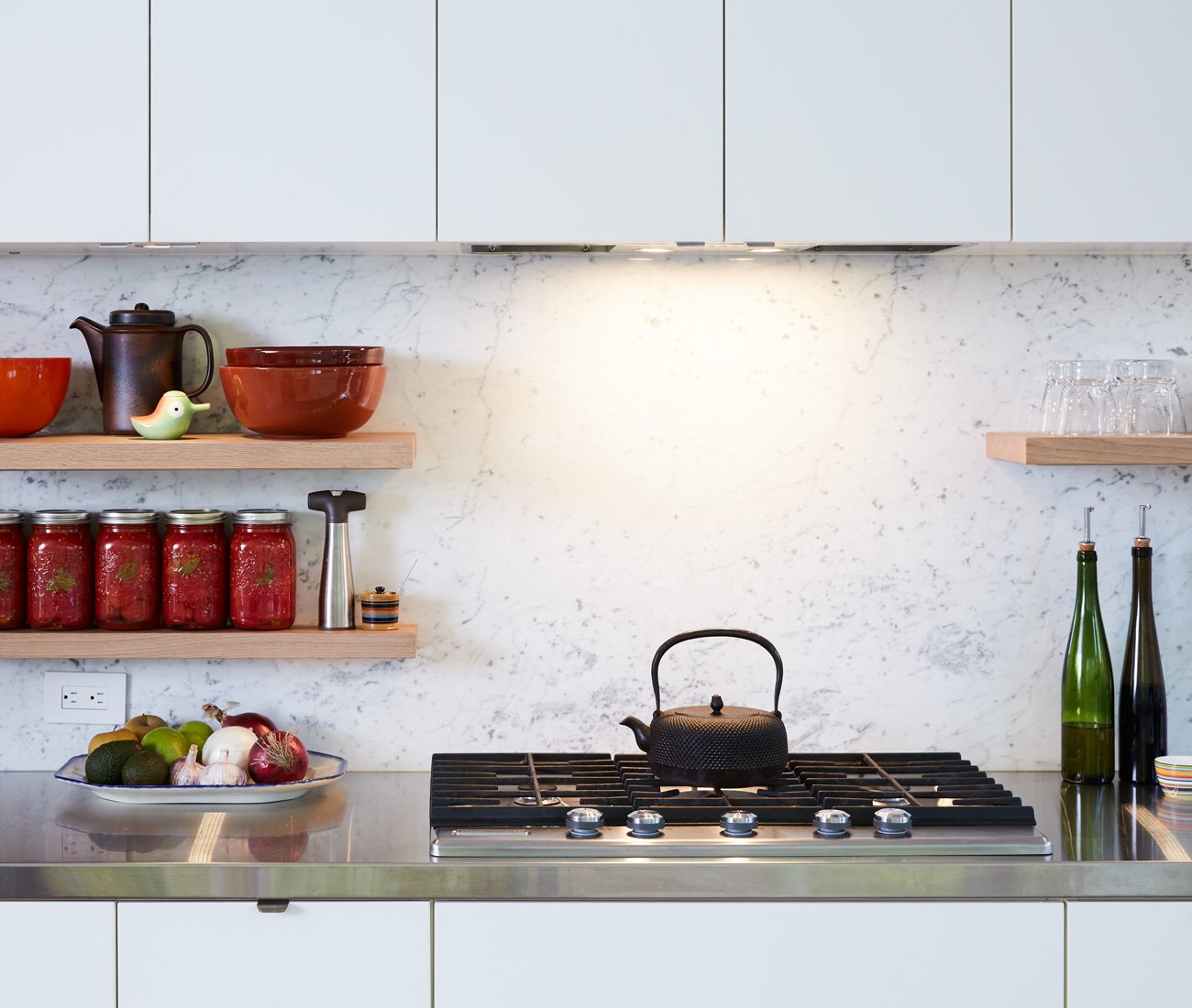Carrara kitchen backsplash; range by KitchenAid