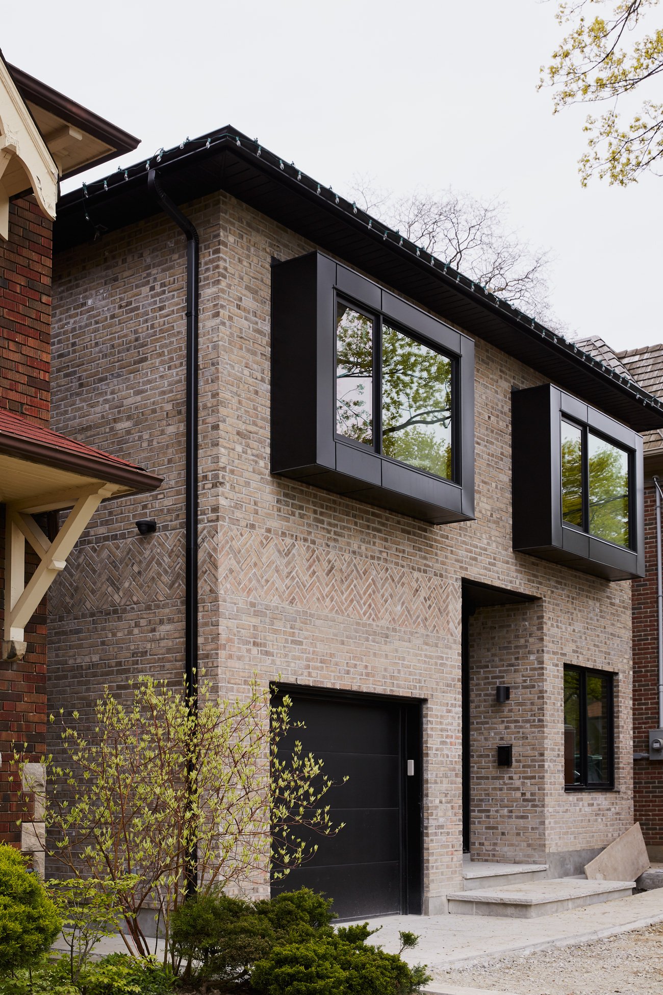 Aluminum-clad windows extending 45 centimeters from the Glen-Gery Brick facade, designed to maximize southern sunlight. - Sixteen Degree Studio