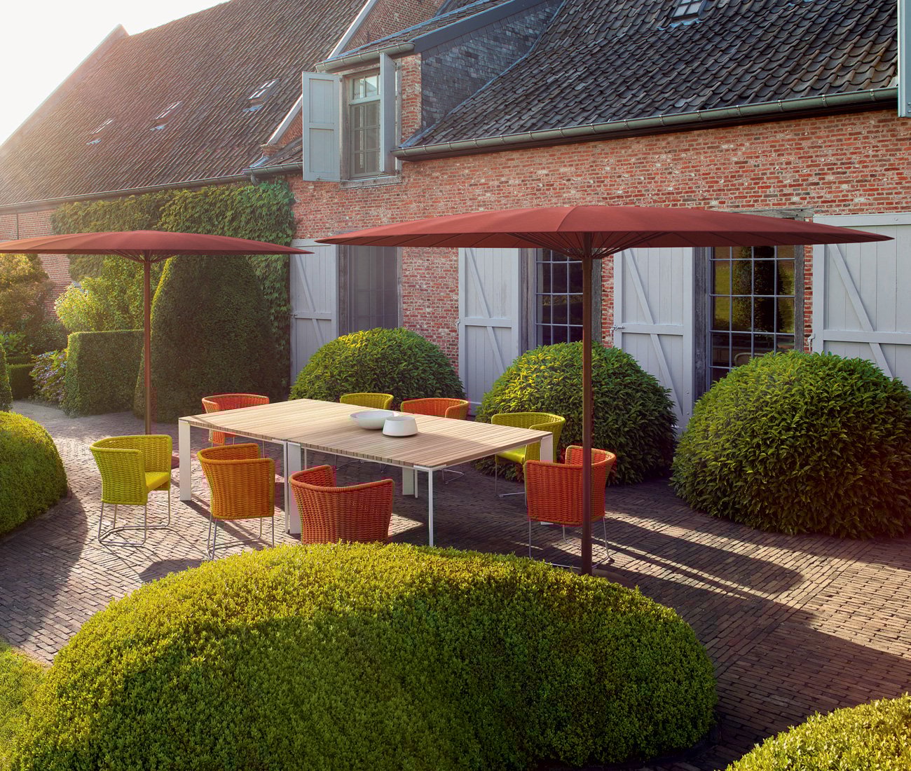 patio furniture solutions Paola Lenti’s dazzling flat or dome-shaped Bistro parasols