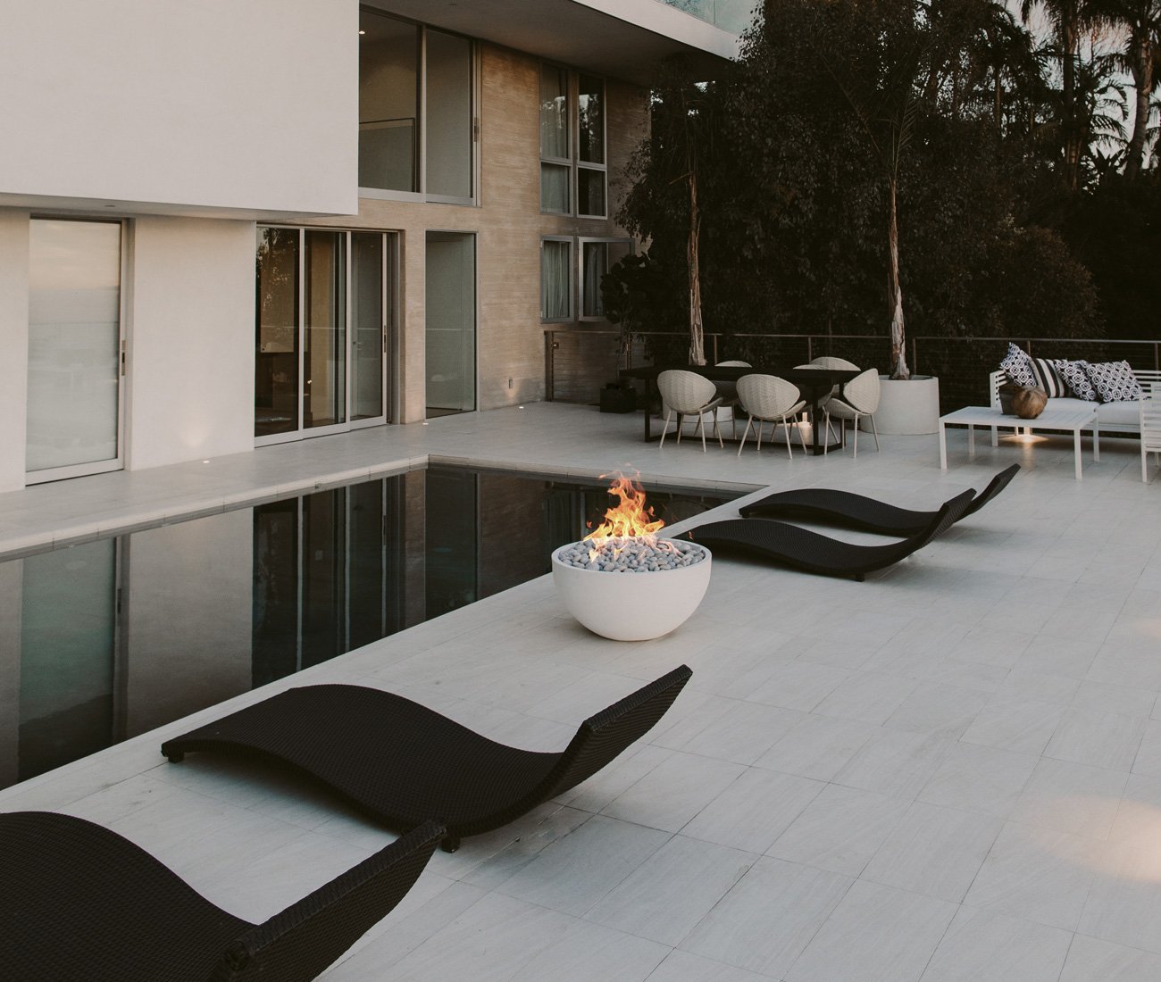 patio furniture solutions lightweight concrete fire pit handcrafted locally by Dekko Concrete near a pool with lounge chairs