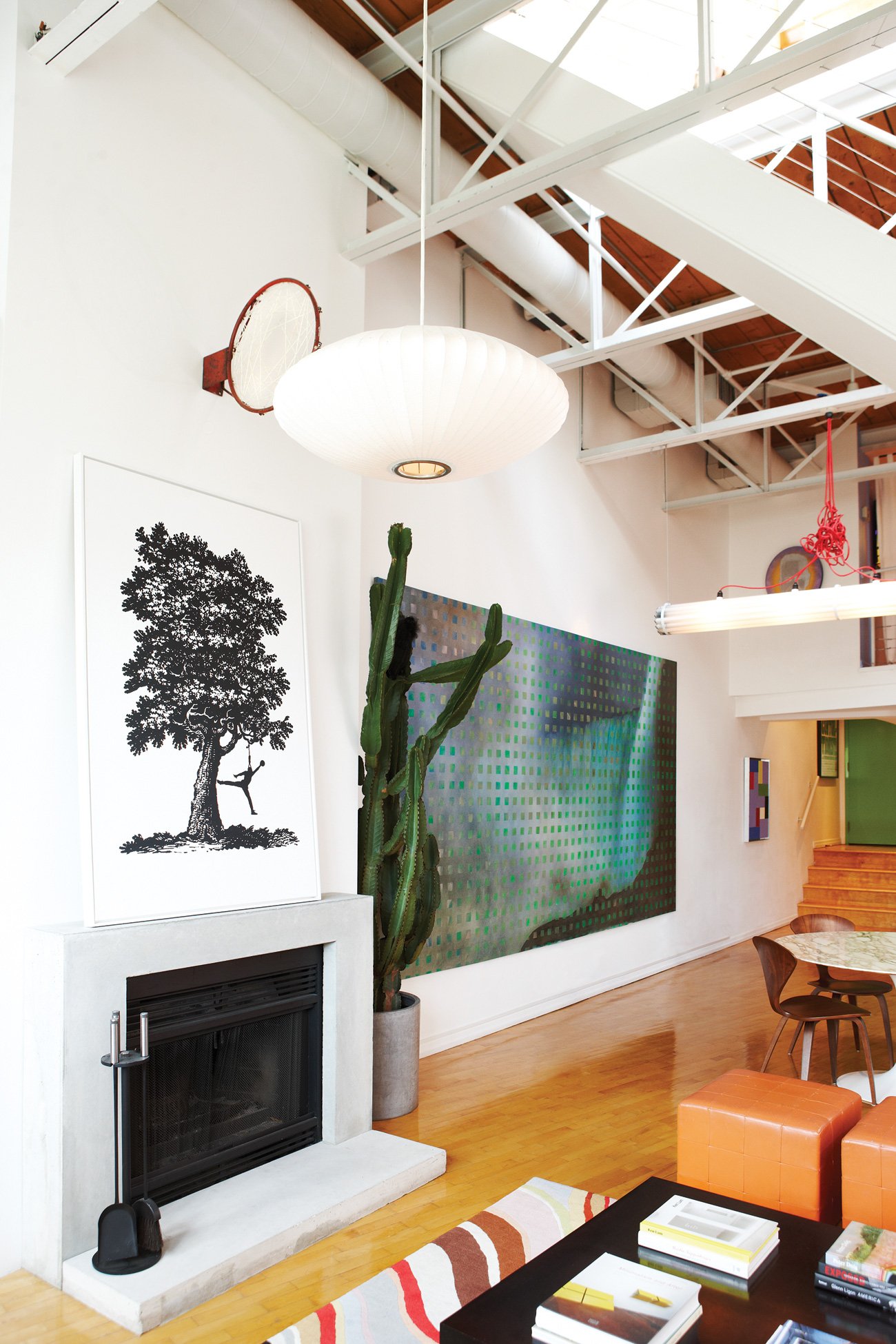 Fashion District Loft with Art on mantel with dreamcatcher and abstract painting on wall.