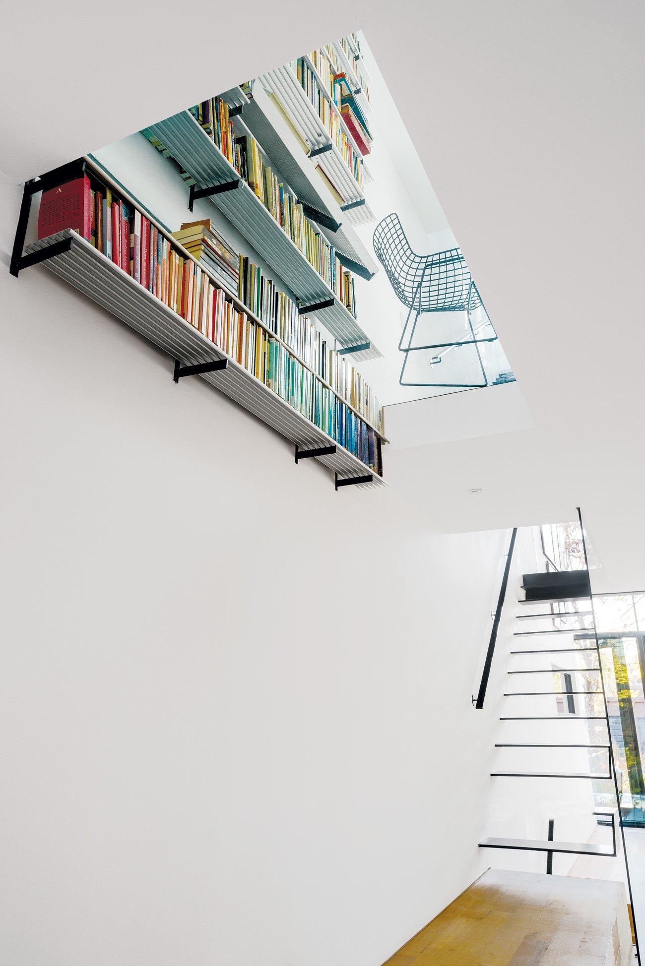 Home Library Ideas Design Designlines Magazine Home Library Ideas with designer Johnson Chou’s aluminum bookshelves appearing to pass through a glass floor.