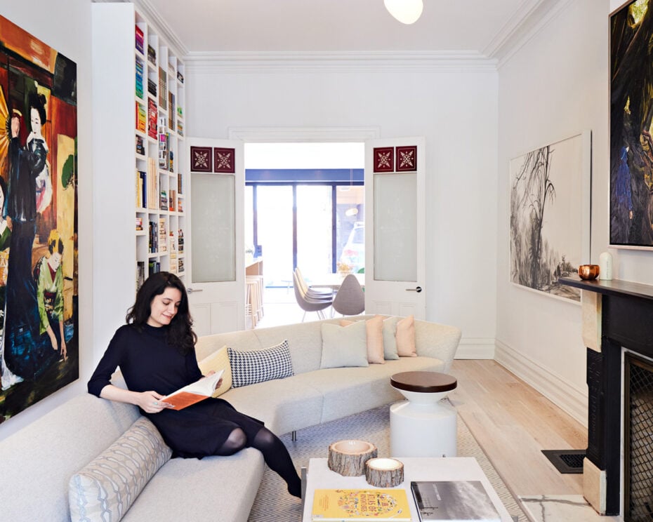 A young woman is sitting on a living room couch, Home Library Ideas Design Designlines Magazine