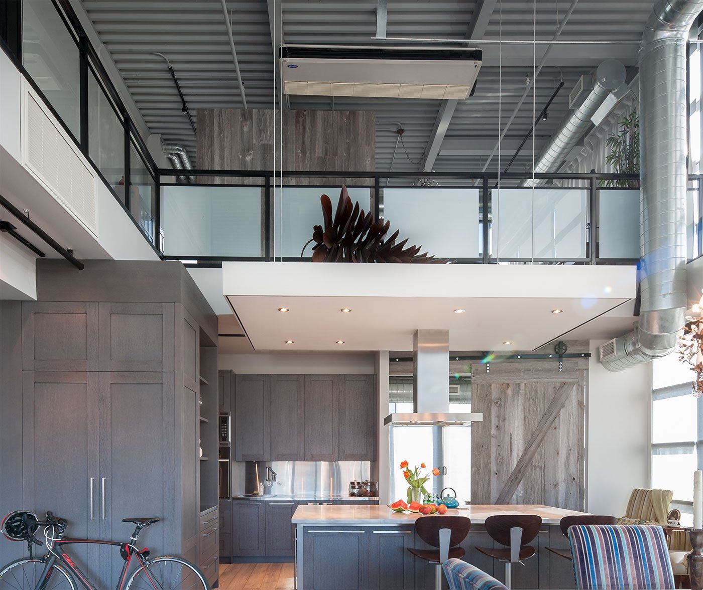 Kitchen design, on a grey tone, with high ceiling, range hood suspended over island - Yorkville Design Centre - Thomas Tampold