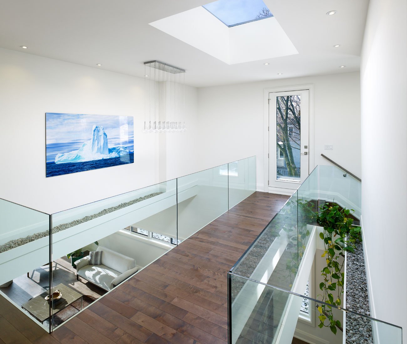 catwalk - suspended like a drawbridge over the green heart of the home