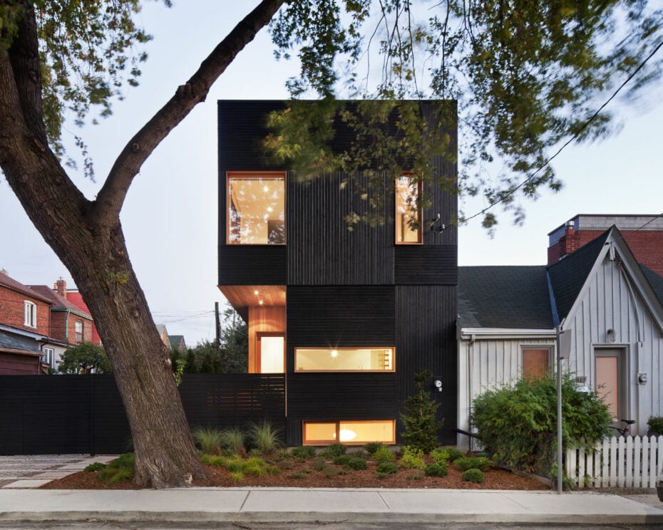 Black wood siding covers the exterior of the modern urban home - Great Lake Studio