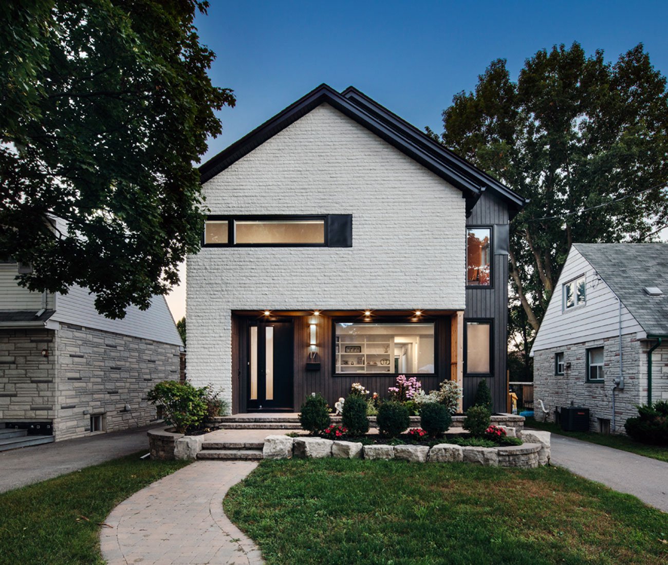 Double Gable House designed by Vanessa Fong, the blackened portion of the house recedes into the background.