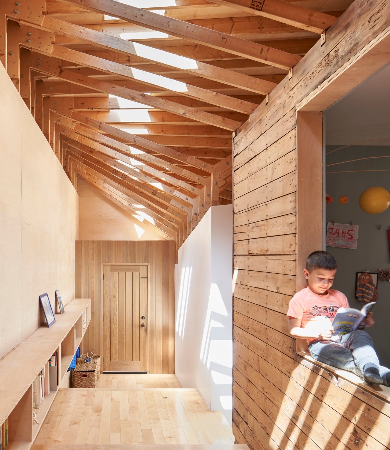North-facing windows open into a bright, skylit play area in Joey Giaimo’s bungalow addition