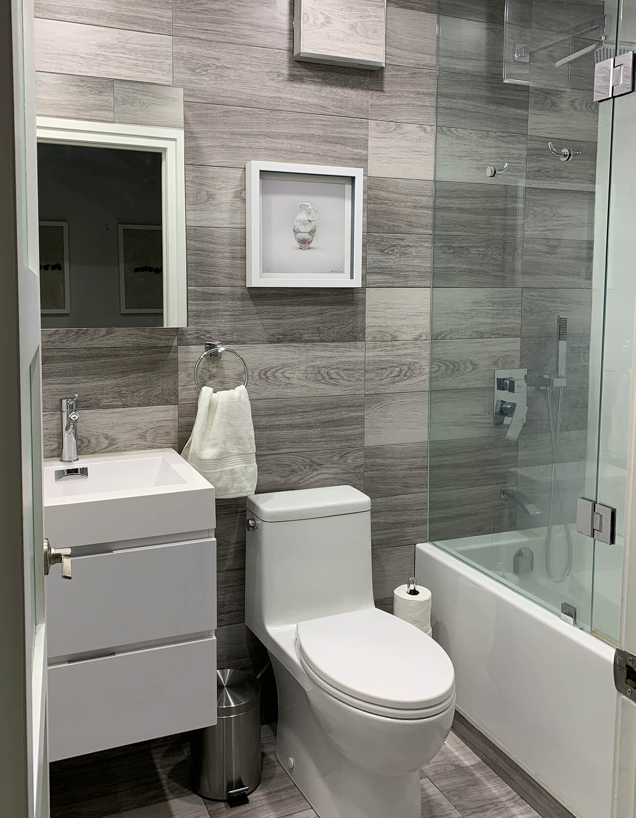deeper tub from Home Depot and a floating vanity, sink, medicine cabinet and Caroma Caravelle toilet