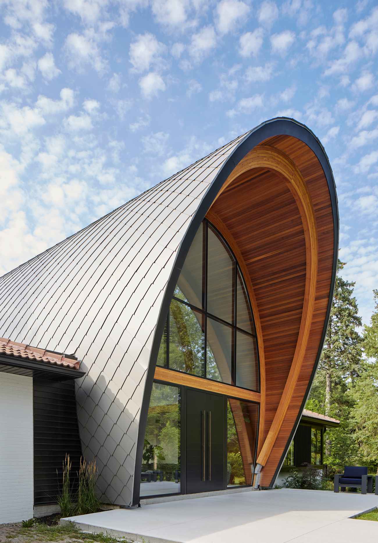 Arcing, double-height atrium modern additions to transform a traditional Mississauga home into an hacienda-style house
