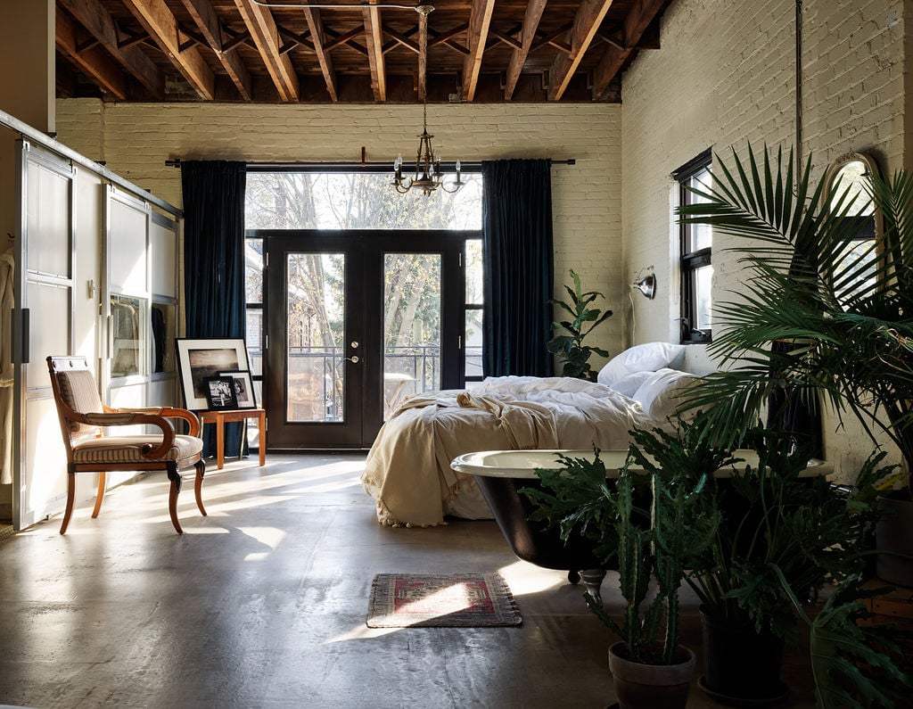 Bedroom with accent chair and vintage chandelier