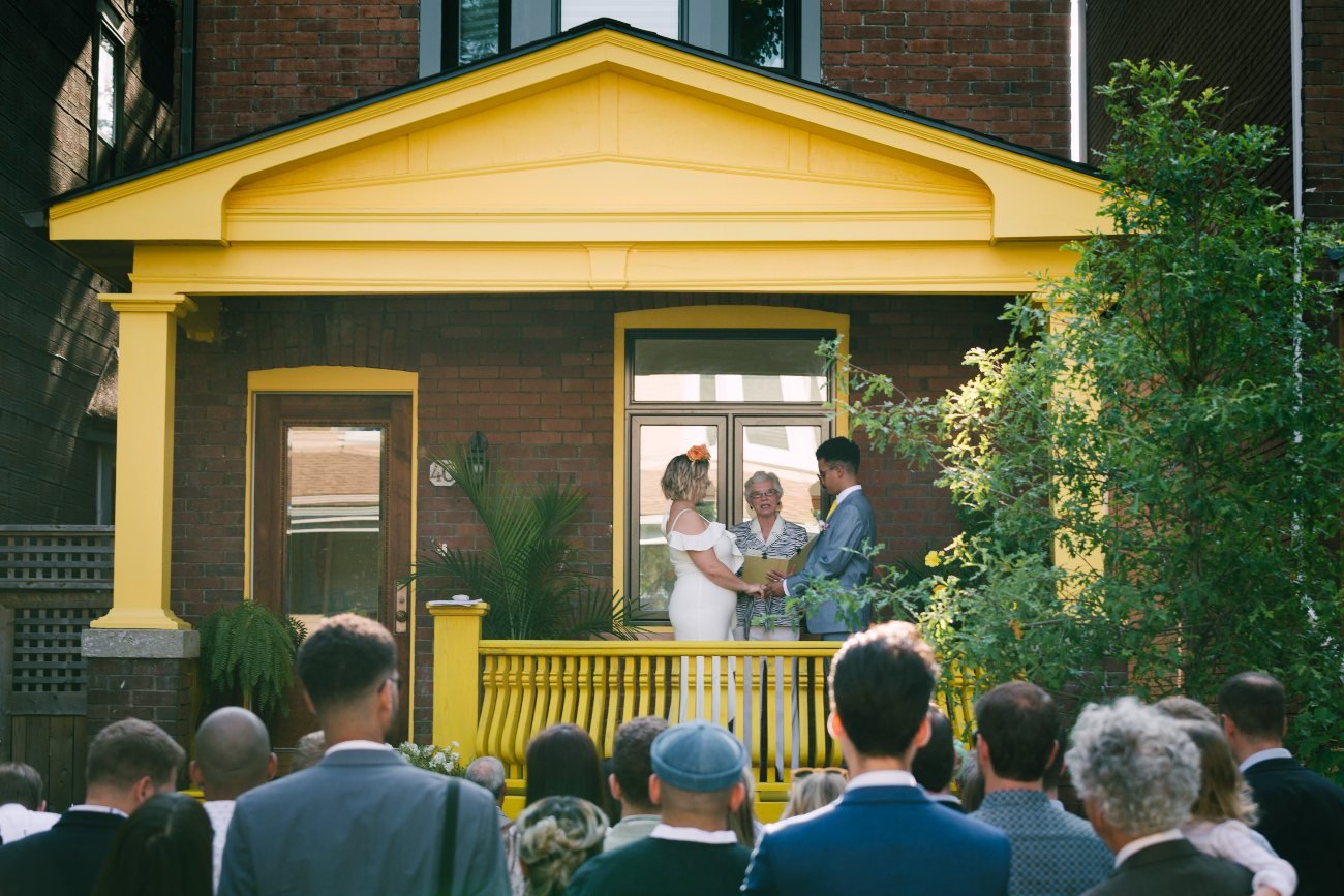 A wedding celebrated on a yellow front porch