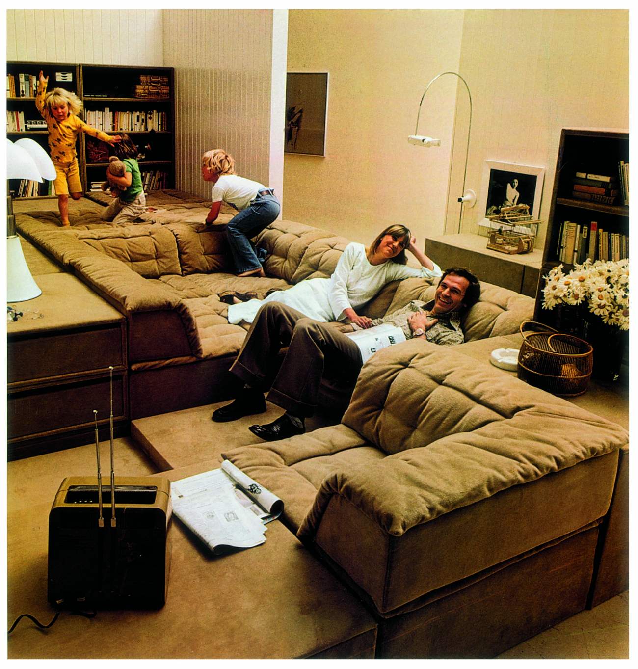 Family with kids relaxing on sofa