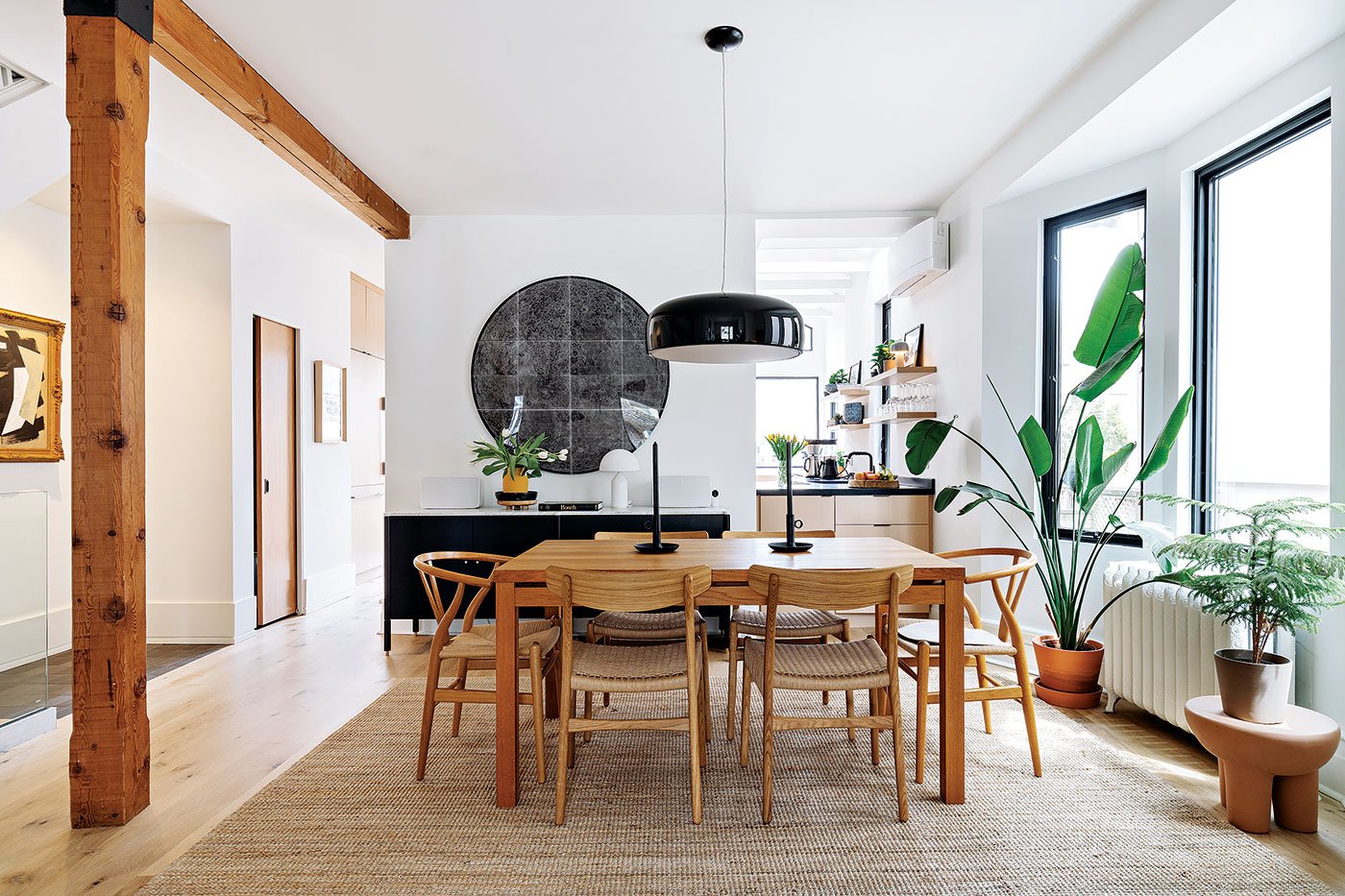 Dining table with Flos light pendant, A partial wall maintains privacy but lets light flow in. Architect Heather Asquith Beach semi