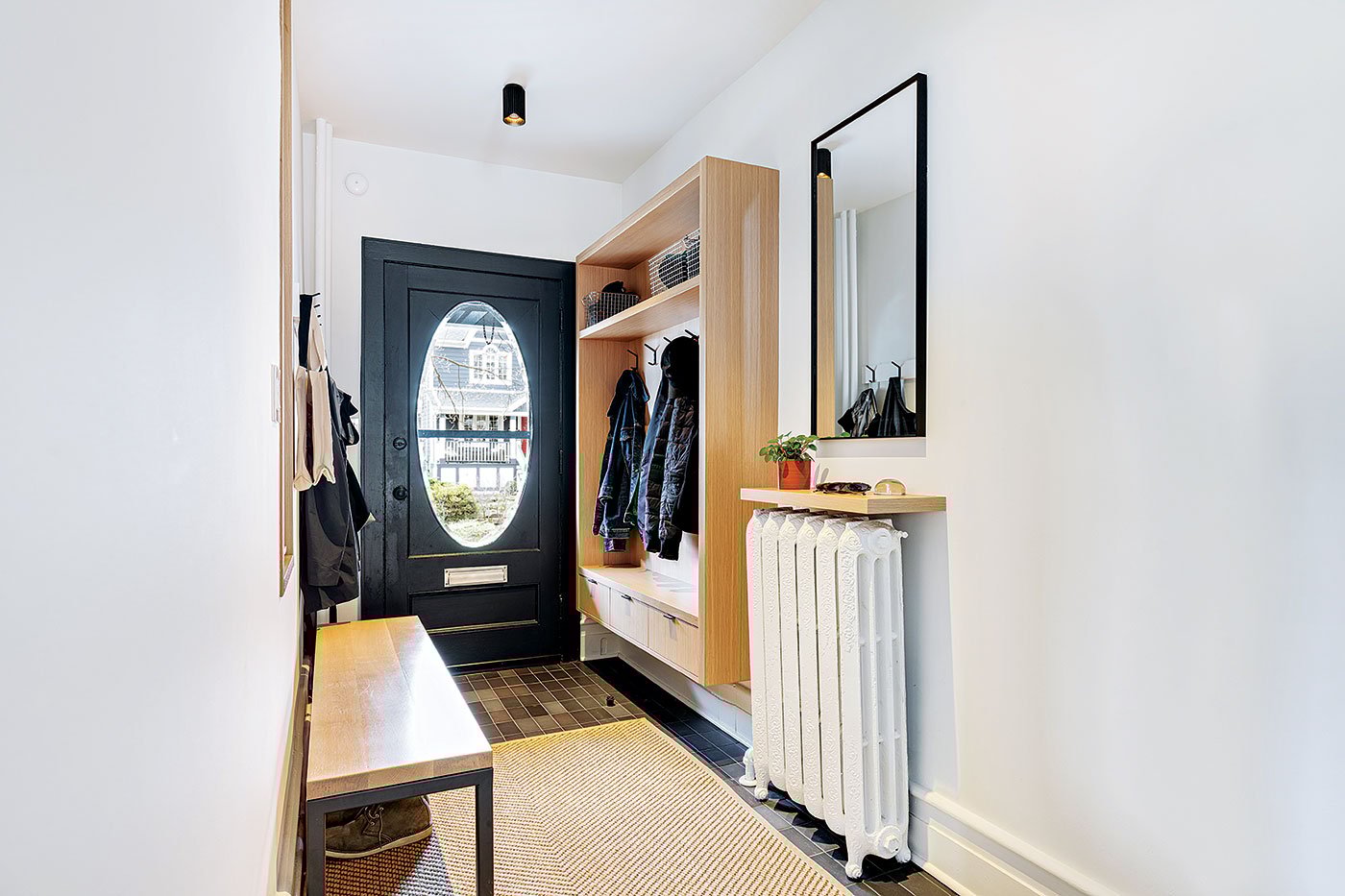 Framing the foyer’s coat hooks with millwork, Architect Heather Asquith Beach semi
