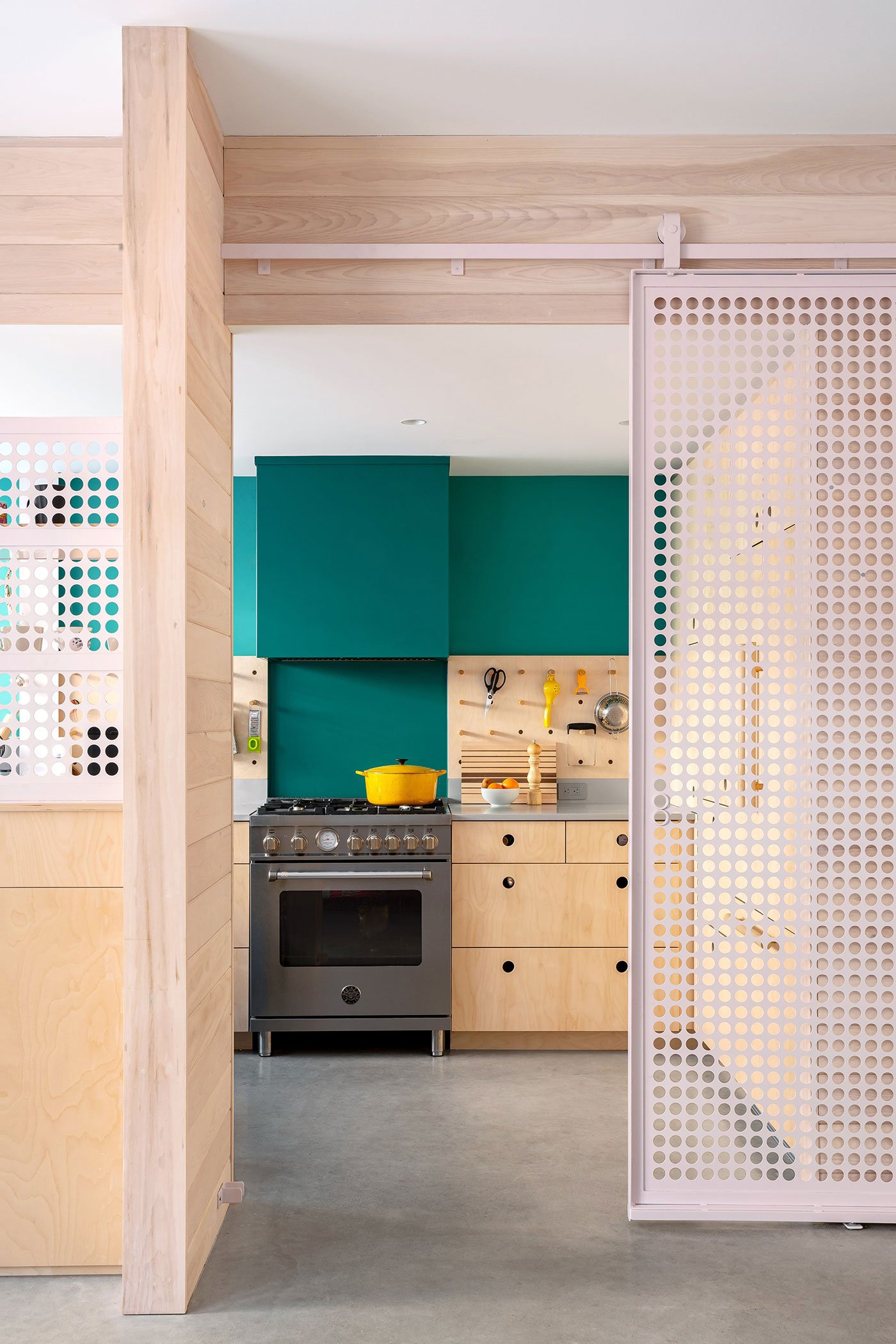 Sliding door divider with a kitchen in background