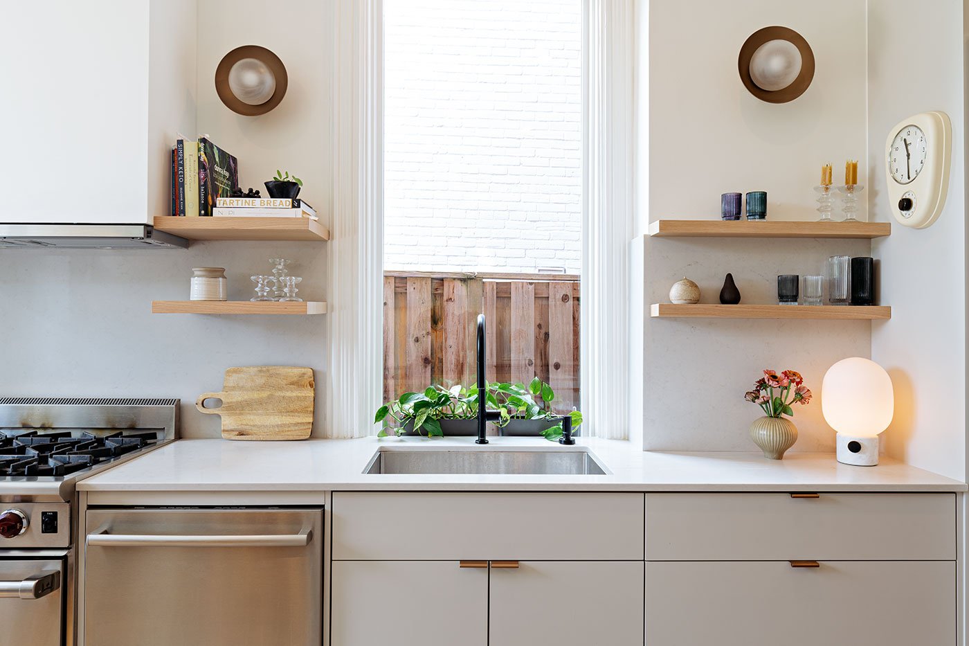 Designer Lisa Lev prioritized lighting including sconces by Luminaire Authentik.Millwork, California Kitchens; faucet, Hans Grohe; lamp, Design Within Reach.