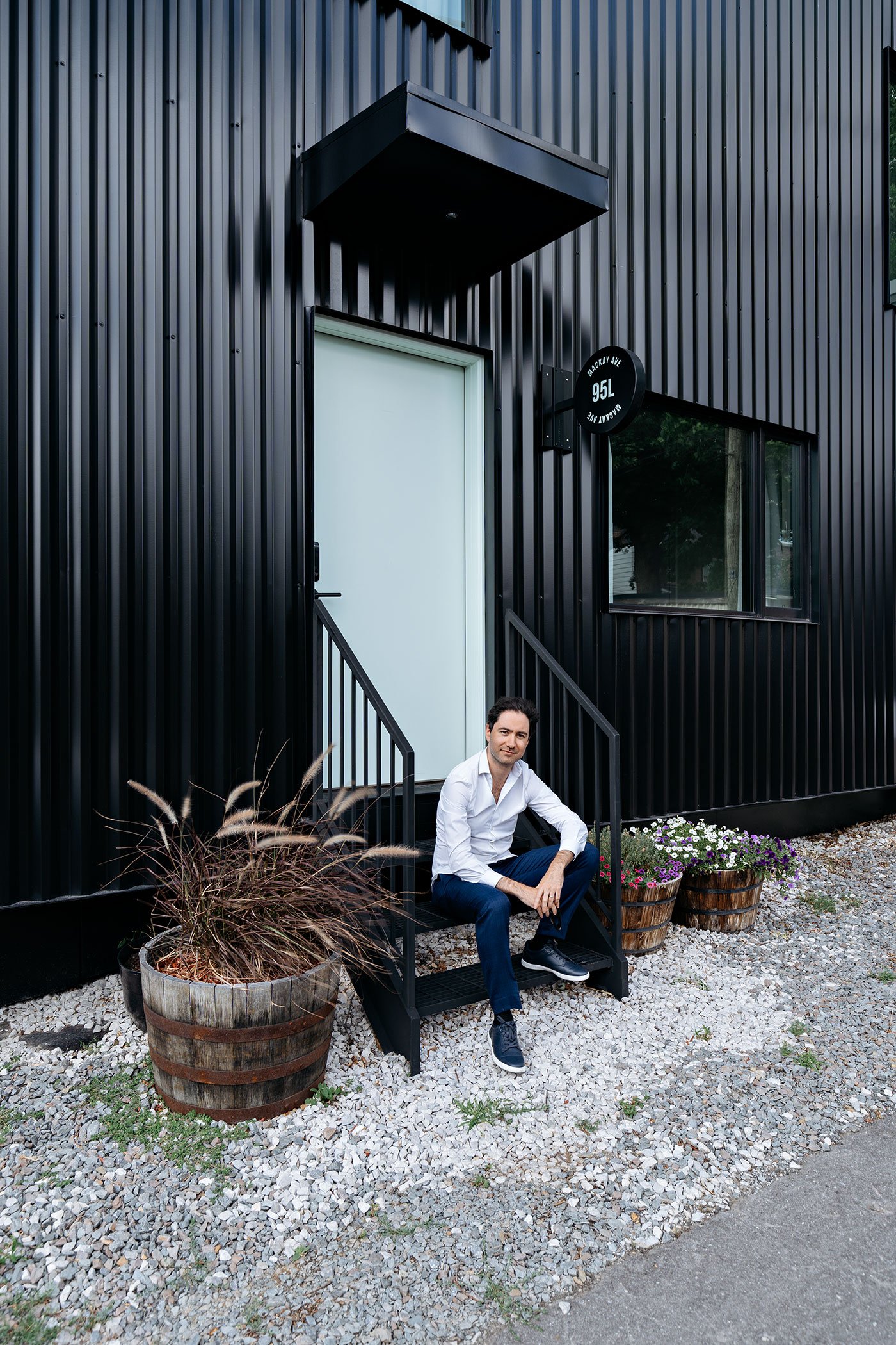 architect Gabriel Fain sitting in front of the laneway house near Corso Italia